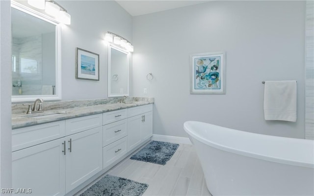 bathroom featuring vanity and a tub