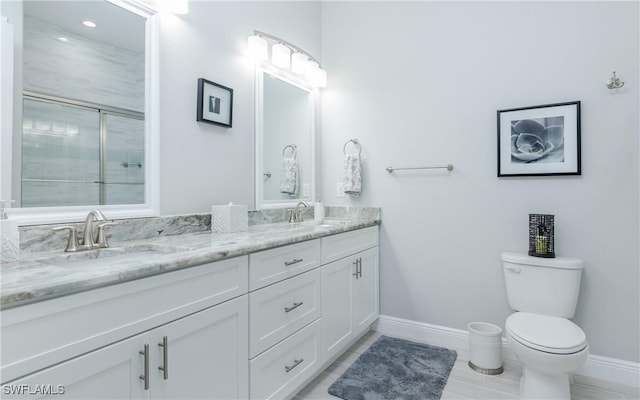 bathroom featuring vanity, toilet, tile patterned floors, and walk in shower