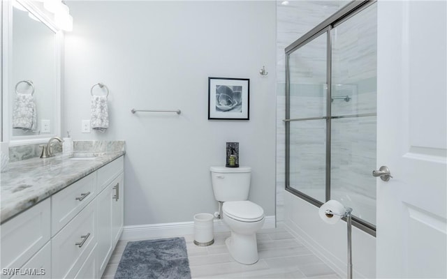 bathroom featuring vanity, toilet, tile patterned floors, and walk in shower