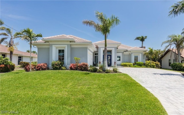 mediterranean / spanish home with a front yard