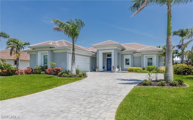 view of front of home featuring a garage and a front yard