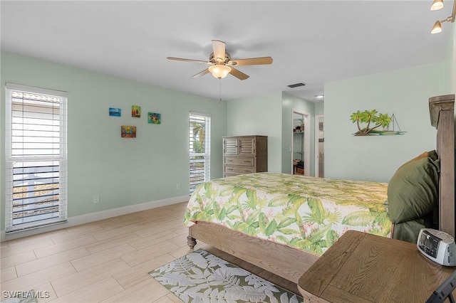 bedroom with multiple windows and ceiling fan