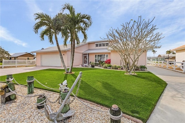 view of front of property featuring a garage and a front lawn