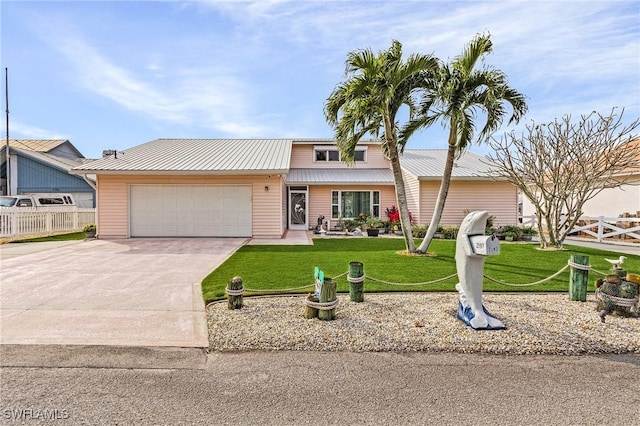 view of front of house featuring a front yard and a garage