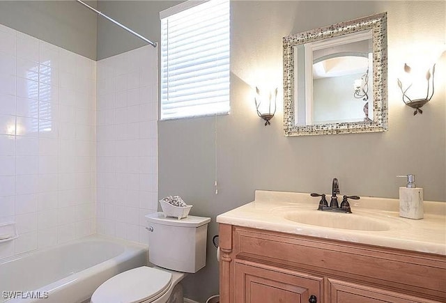 full bathroom with vanity, tiled shower / bath, and toilet