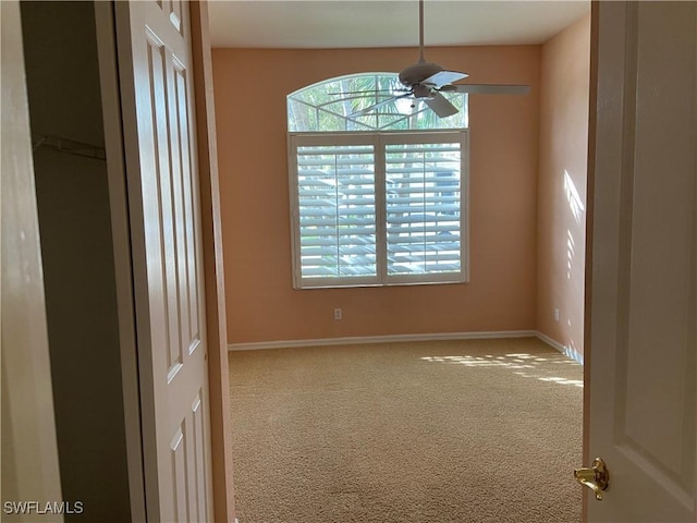 carpeted empty room featuring plenty of natural light and ceiling fan