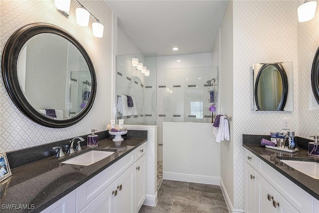 bathroom with vanity and tiled shower