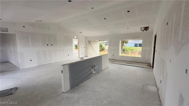 kitchen featuring lofted ceiling, open floor plan, and plenty of natural light