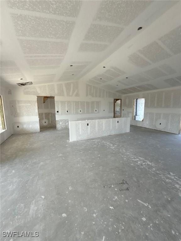 unfurnished living room with lofted ceiling