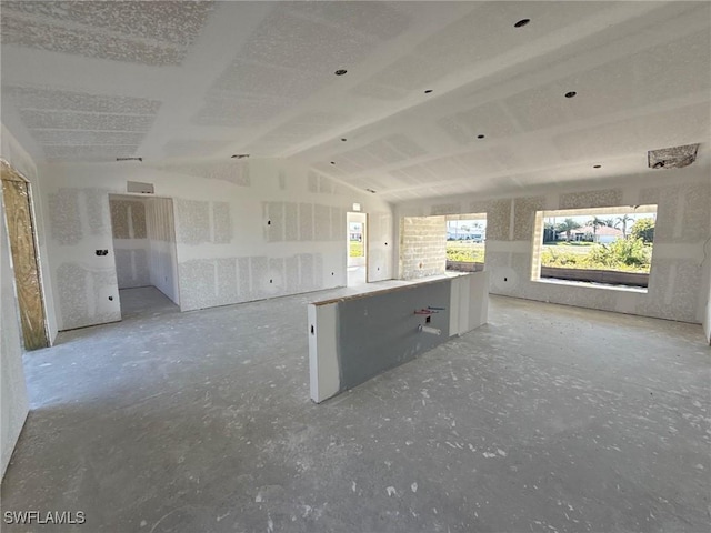 spare room with lofted ceiling