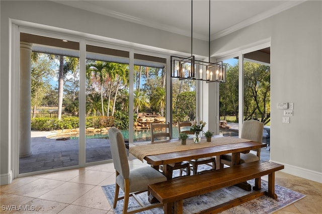 dining area featuring ornamental molding, a chandelier, baseboards, and light tile patterned flooring