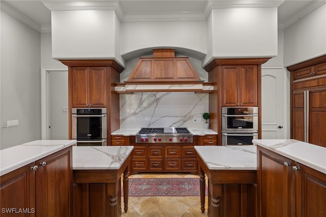 kitchen with appliances with stainless steel finishes, tasteful backsplash, crown molding, custom range hood, and light stone counters