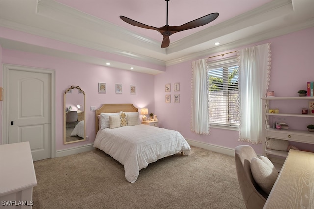 bedroom featuring ceiling fan, ornamental molding, a raised ceiling, and light carpet