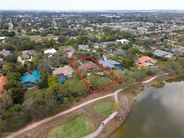 aerial perspective of suburban area with property parcel outlined and a large body of water