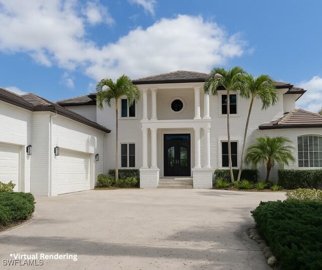 view of front facade with a garage, driveway, and french doors
