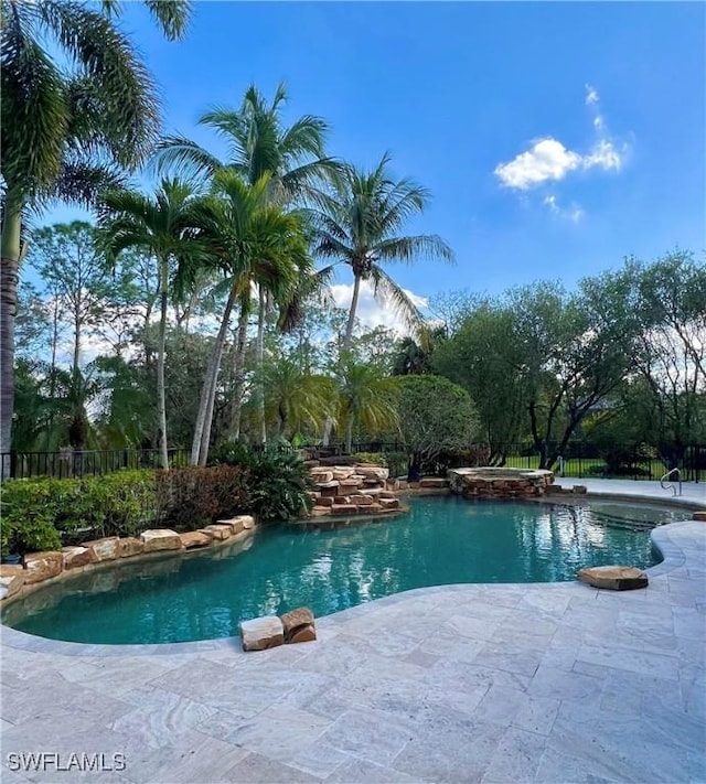 view of pool featuring fence and a patio