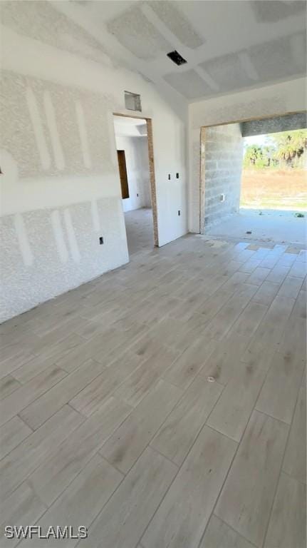 interior space featuring vaulted ceiling and wood finish floors