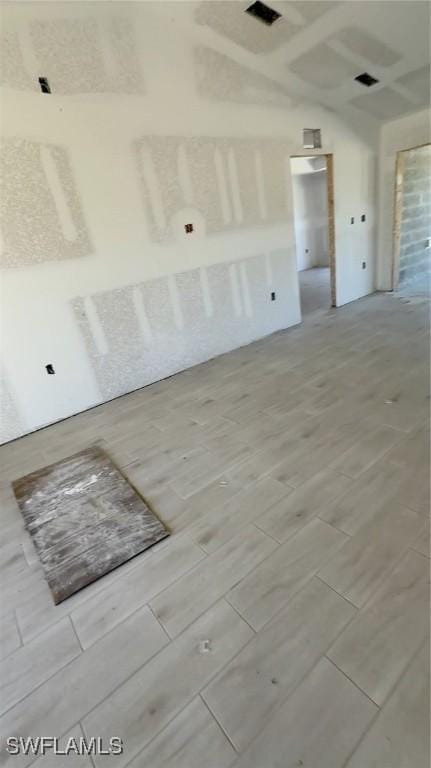 unfurnished room with wood tiled floor and visible vents