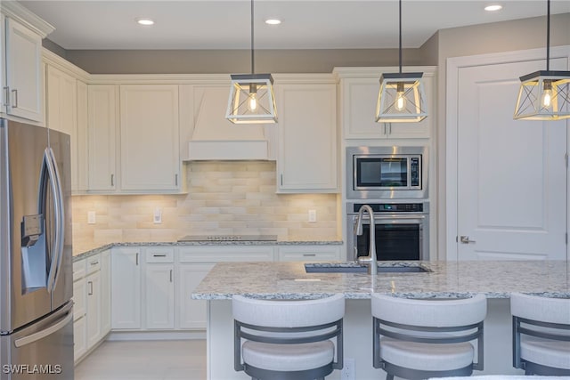 6217 Harmony Dr, Ave Maria, FL 34142 - kitchen with white cabinets and stainless steel appliances