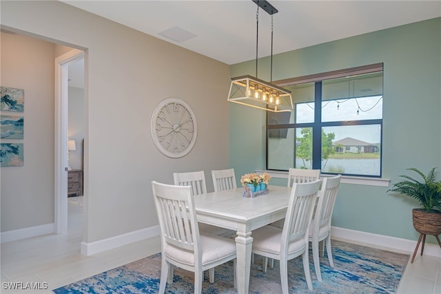 6217 Harmony Dr, Ave Maria, FL 34142 - tiled dining area featuring a chandelier and baseboards