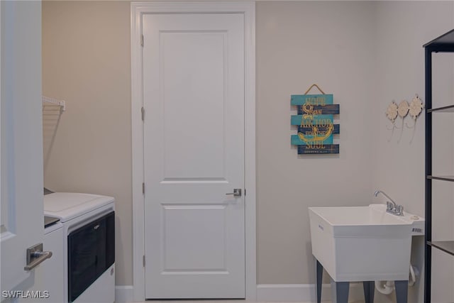 6217 Harmony Dr, Ave Maria, FL 34142 - clothes washing area with a sink, baseboards, washing machine and dryer, and laundry area