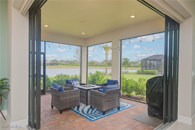 6217 Harmony Dr, Ave Maria, FL 34142 - sunroom featuring an outdoor fire pit and a water view