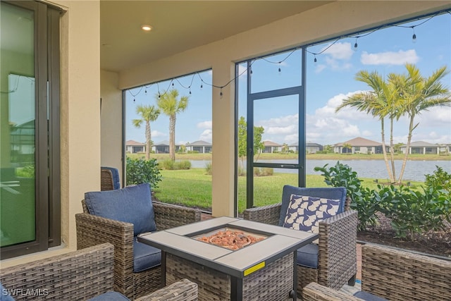 6217 Harmony Dr, Ave Maria, FL 34142 - sunroom with an outdoor fire pit, a residential view, and a water view