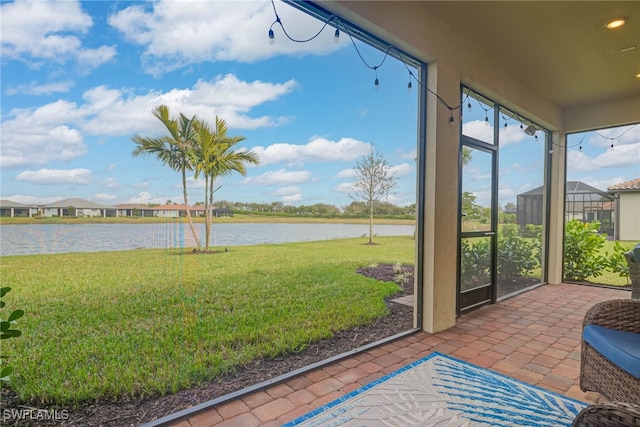 6217 Harmony Dr, Ave Maria, FL 34142 - sunroom / solarium featuring a water view