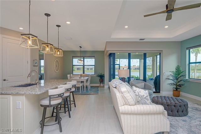 6217 Harmony Dr, Ave Maria, FL 34142 - living room featuring recessed lighting, baseboards, a ceiling fan, and a raised ceiling
