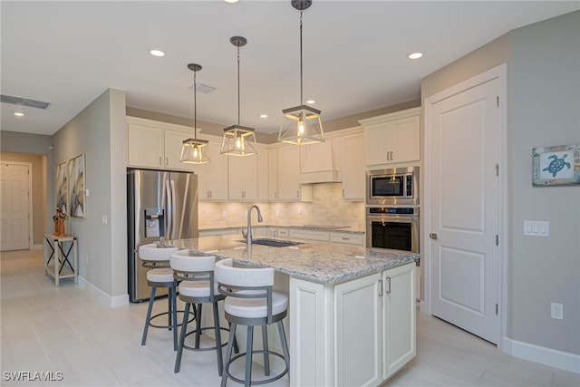 6217 Harmony Dr, Ave Maria, FL 34142 - kitchen with tasteful backsplash, baseboards, visible vents, stainless steel appliances, and a sink