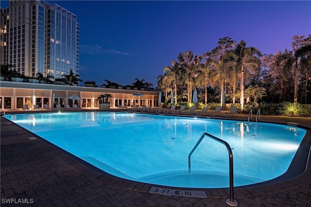 view of pool at dusk