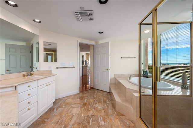 bathroom featuring vanity and shower with separate bathtub