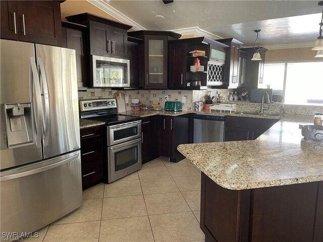 kitchen featuring ornamental molding, pendant lighting, light tile patterned flooring, and stainless steel appliances