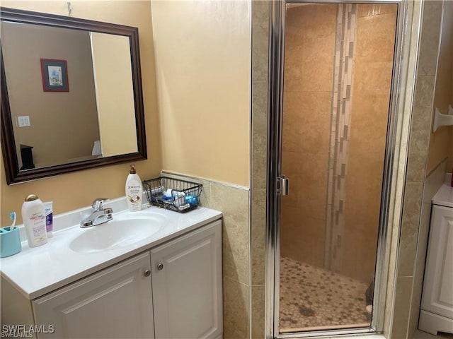 bathroom featuring vanity and a shower with door