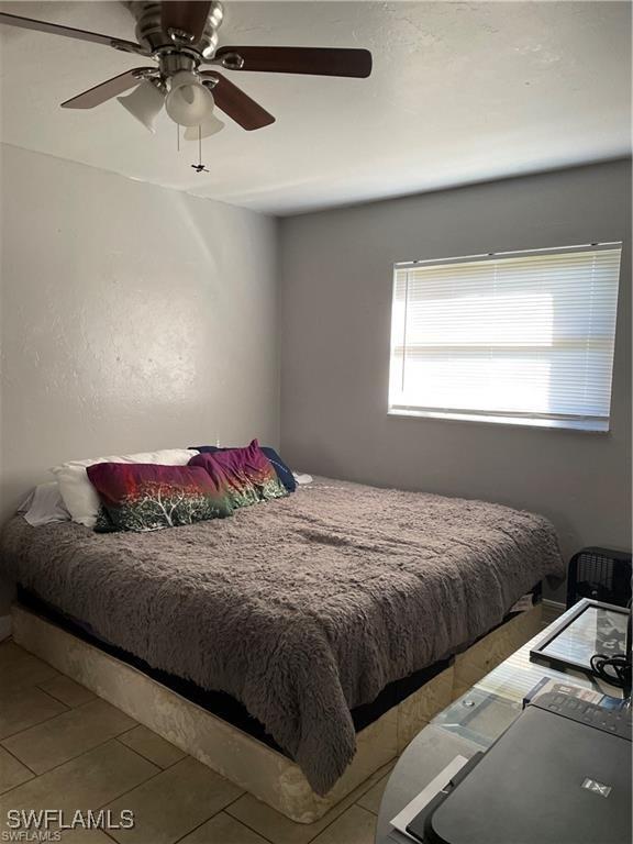 bedroom with tile patterned flooring and a ceiling fan