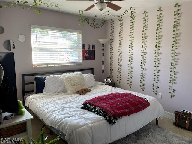 bedroom with ceiling fan and tile patterned floors