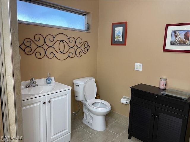 bathroom featuring tile patterned floors, vanity, and toilet