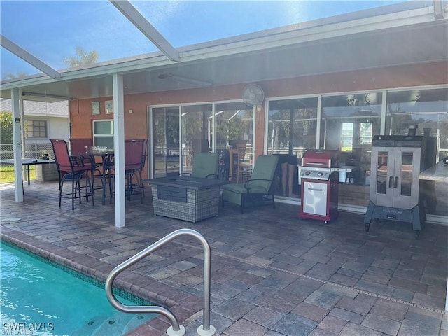 view of patio / terrace featuring an outdoor bar, an outdoor pool, and grilling area