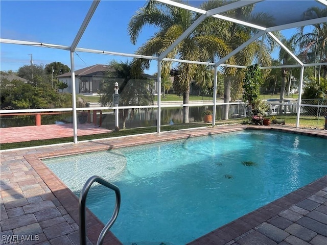 view of pool featuring a patio area, a lanai, and a water view