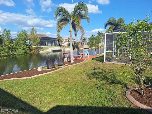 view of yard with a water view and glass enclosure