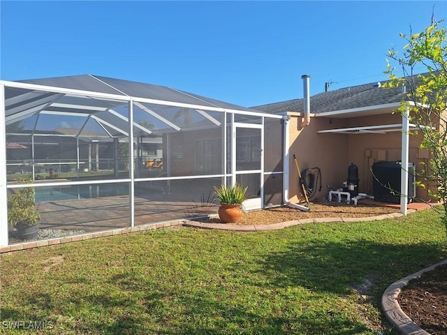 exterior space with a lanai, a lawn, stucco siding, an outdoor pool, and a patio area