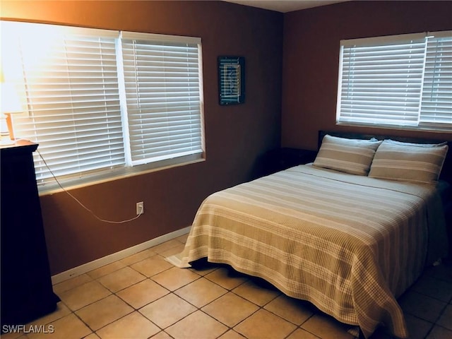 bedroom featuring tile patterned floors and multiple windows