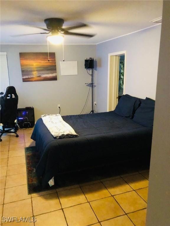 tiled bedroom featuring ceiling fan