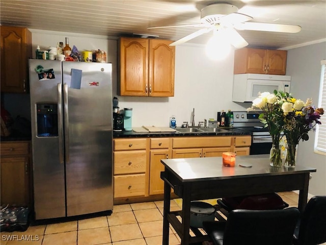 kitchen featuring sink, light tile patterned floors, ceiling fan, stainless steel appliances, and ornamental molding