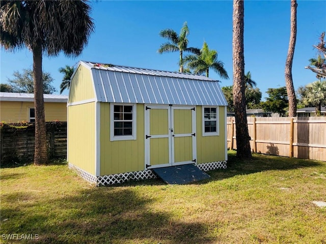 view of outbuilding featuring a lawn