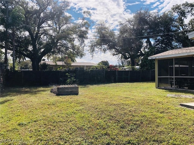 view of yard featuring a sunroom