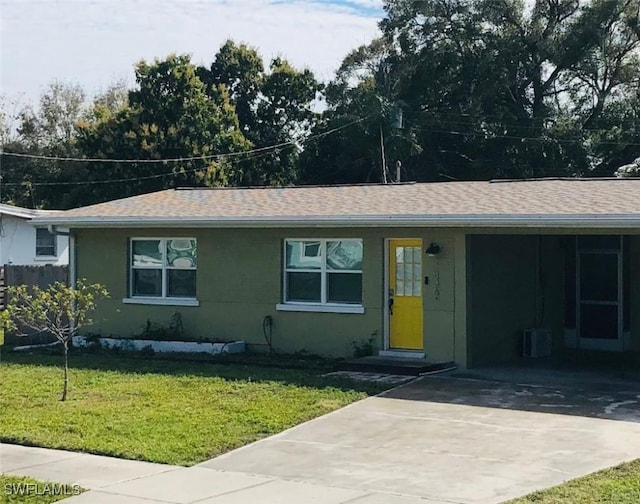 single story home featuring central AC unit, a front lawn, and a carport