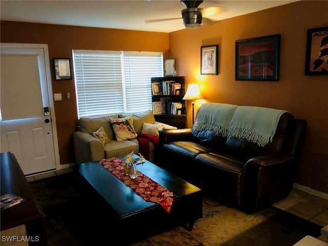 tiled living room with ceiling fan