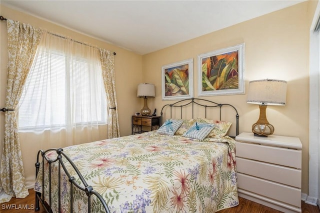 bedroom featuring multiple windows and dark wood-type flooring
