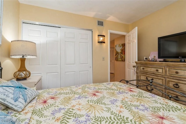 bedroom with a closet and visible vents
